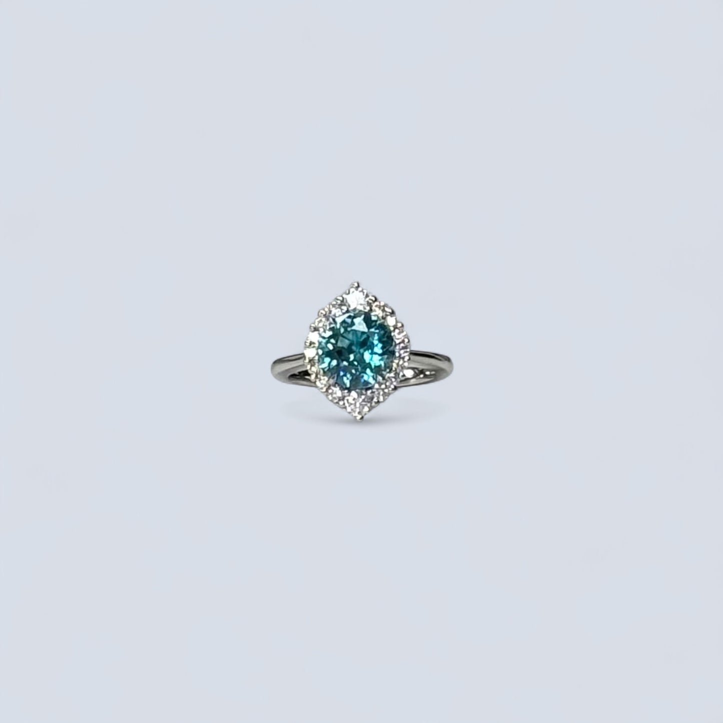 Ring with a blue gemstone on a light gray background