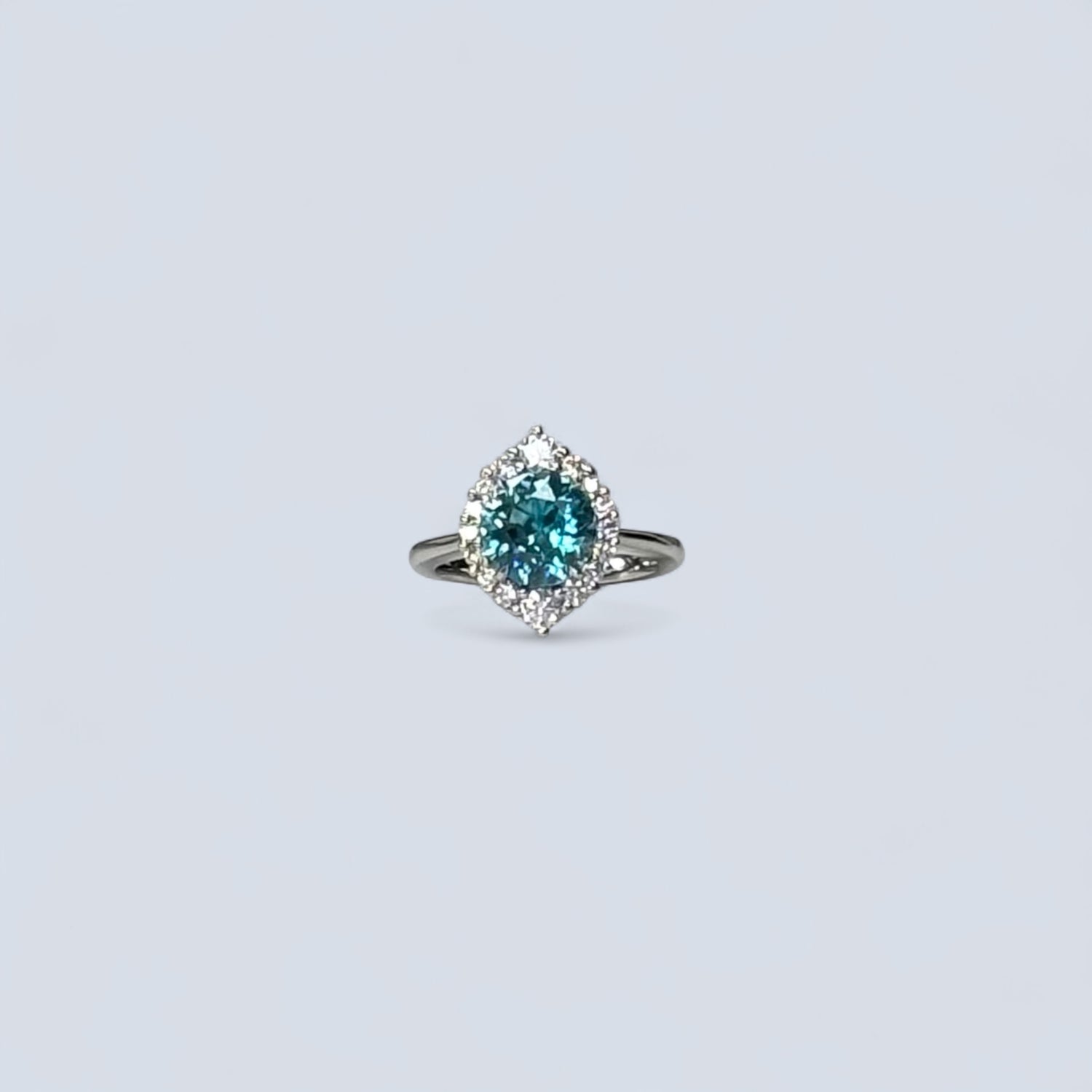 Ring with a blue gemstone on a light gray background