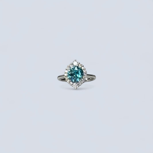 Ring with a blue gemstone on a light gray background