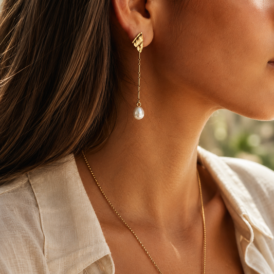Elegant textured sea shells long earrings with  freshwater pearl drops on a model